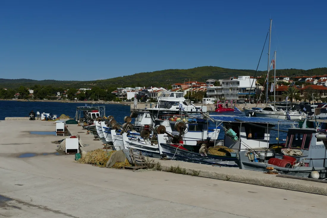 Fishing boats and crates on the quay at Nikiti, the village behind