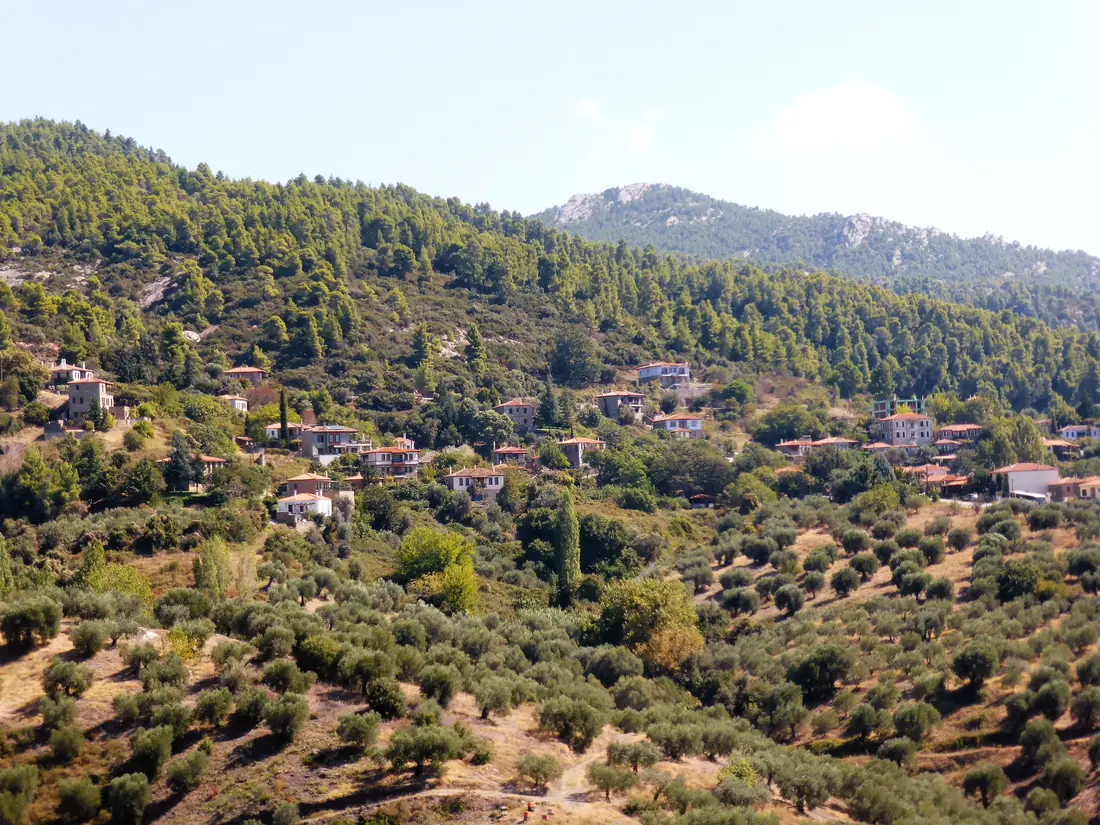 The mountain village of Parthenonas, its restored stone houses on the wooded slope of Itamos